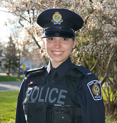 Female cadet in front an HRPS cruiser