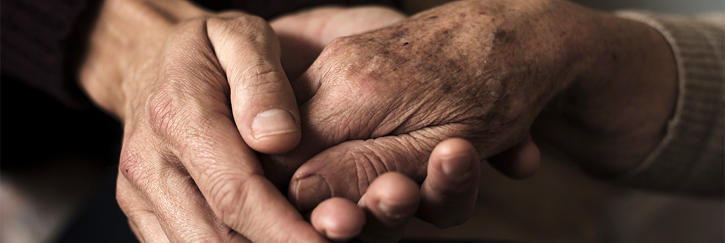 Young hand holding the hand of an elderly person