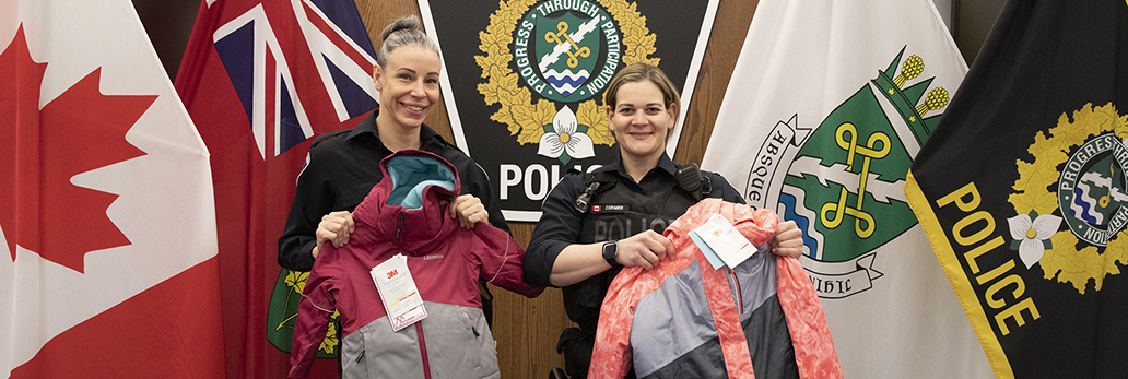 Officers displaying donated winter clothing