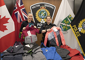 Officers displaying donated winter clothing