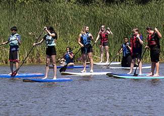 HRPS and Youths paddle boarding on Bronte Creek