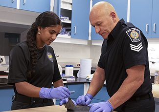 Youth being shown how to dust for fingerprints