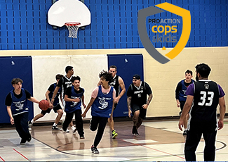 Youth participating in a basketball game against HRPS officers