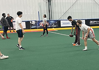 Youth playing football with HRPS Officers
