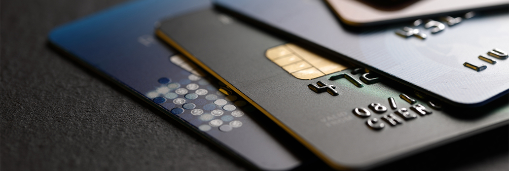 A stack of credit cards lies on a table