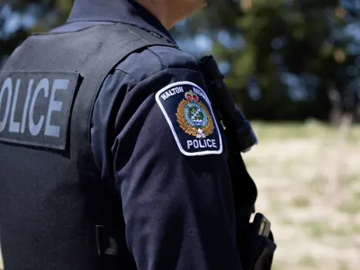 Close up photo of the HRPS Flash on an officers shoulder