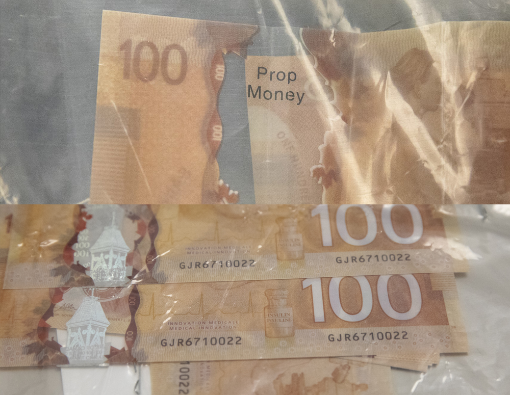 Counterfeit $100 bill with duplicate serial numbers and "Prop Money" written on them