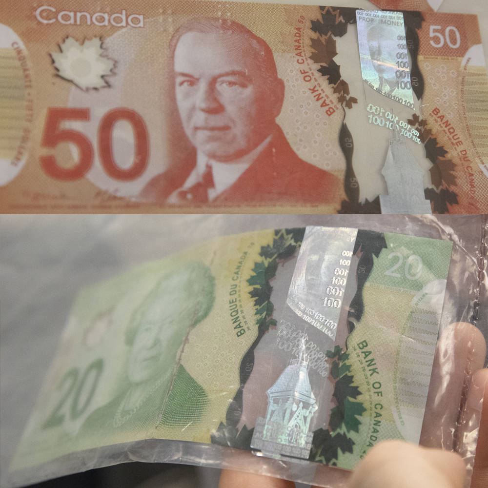Counterfeit $20 and $50 bills with incorrect hologram values and scratches through the images