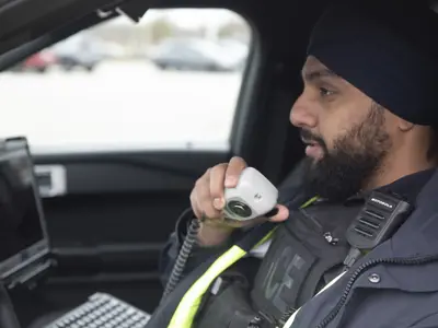 Officer in a cruiser on his radio