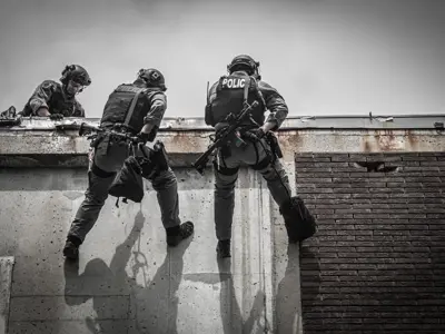 TRU Members repelling down a building