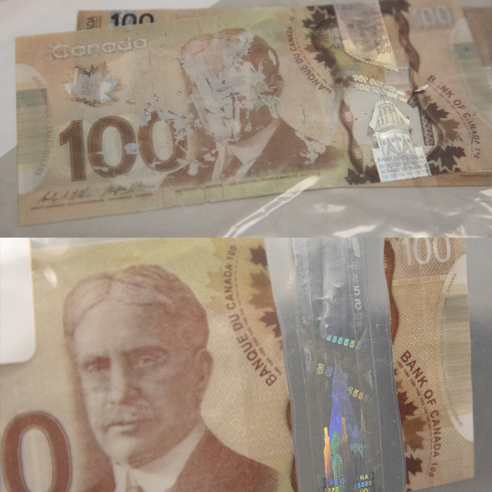 Counterfeit $100 bill scratched off graphics and incorrect hologram values